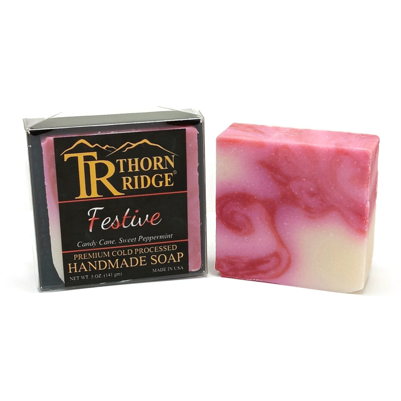 Packaging of Thorn Ridge soap labeled "Festive," described as candy cane, sweet peppermint, premium cold processed, handmade, 5 oz. Made in USA.