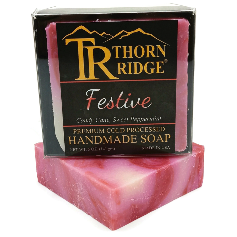 Packaging of Thorn Ridge soap labeled "Festive," described as candy cane, sweet peppermint, premium cold processed, handmade, 5 oz. Made in USA.