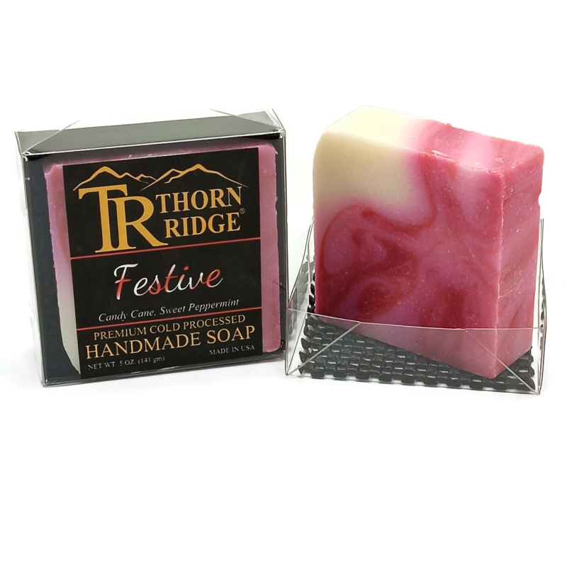 Packaging of Thorn Ridge soap labeled "Festive," described as candy cane, sweet peppermint, premium cold processed, handmade, 5 oz. Made in USA.