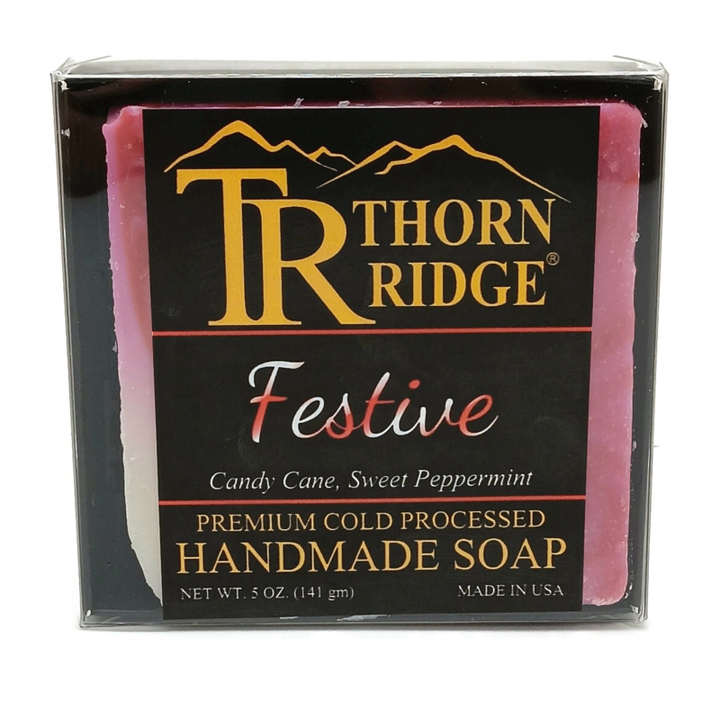 Packaging of Thorn Ridge soap labeled "Festive," described as candy cane, sweet peppermint, premium cold processed, handmade, 5 oz. Made in USA.