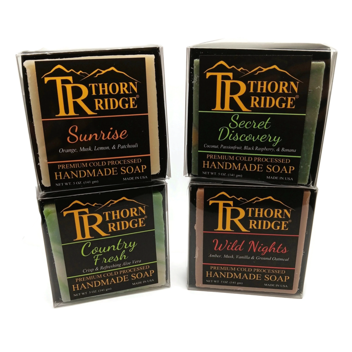 Packaging of Thorn Ridge soap gift set labeled "Fireside Collection," described as containing 4 individually packaged soaps, lathering soap bag, extra mini mat, premium cold processed, handmade, 5 oz each (1 lb 4 oz), Made in USA.