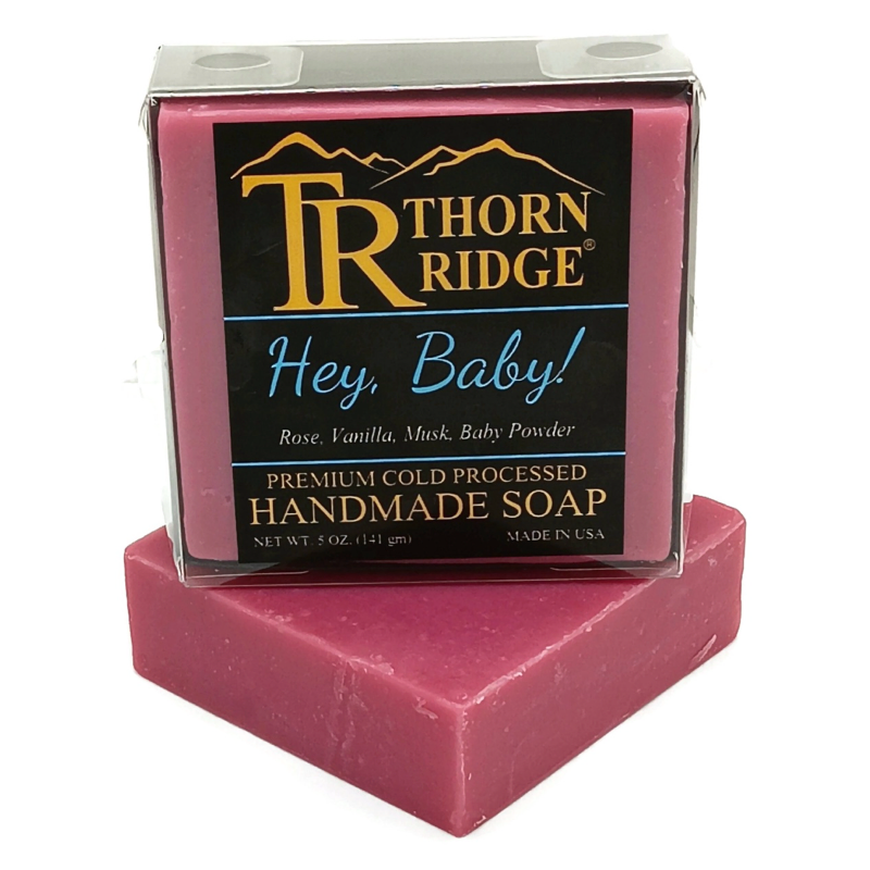 Packaging of Thorn Ridge soap labeled "Hey Baby!," described as rose, vanilla, musk, baby powder, premium cold processed, handmade, 5 oz. Made in USA.