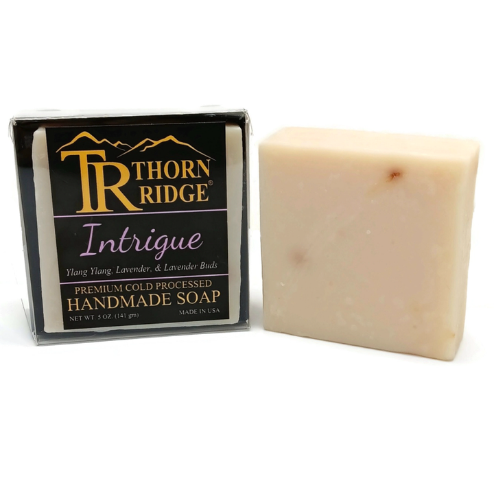 Packaging of Thorn Ridge soap labeled "Intrigue," described as ylang ylang, lavender, lavender buds, premium cold processed, handmade, 5 oz. Made in USA.