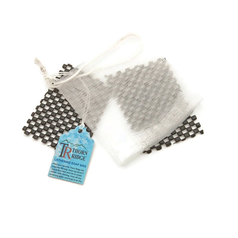 Packaging of Thorn Ridge soap bag labeled "Lathering Soap Bag," described as use white nylon bag to sudse up your soap then hang so soap dries and lasts longer with two exta mini mats.