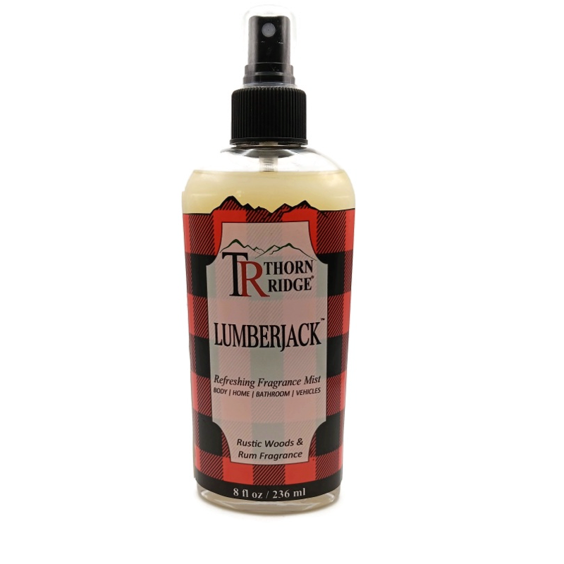 A bottle of Thorn Ridge fragrance mist labeled "Lumberjack," described as a rustic woods and rum scent for body, home, bathroom, and vehicles. 8 fl oz.