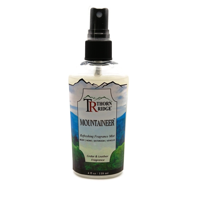 A bottle of Thorn Ridge fragrance mist labeled "Mountaineer," described as a cedar and leather  scent for body, home, bathroom, and vehicles. 4 fl oz.