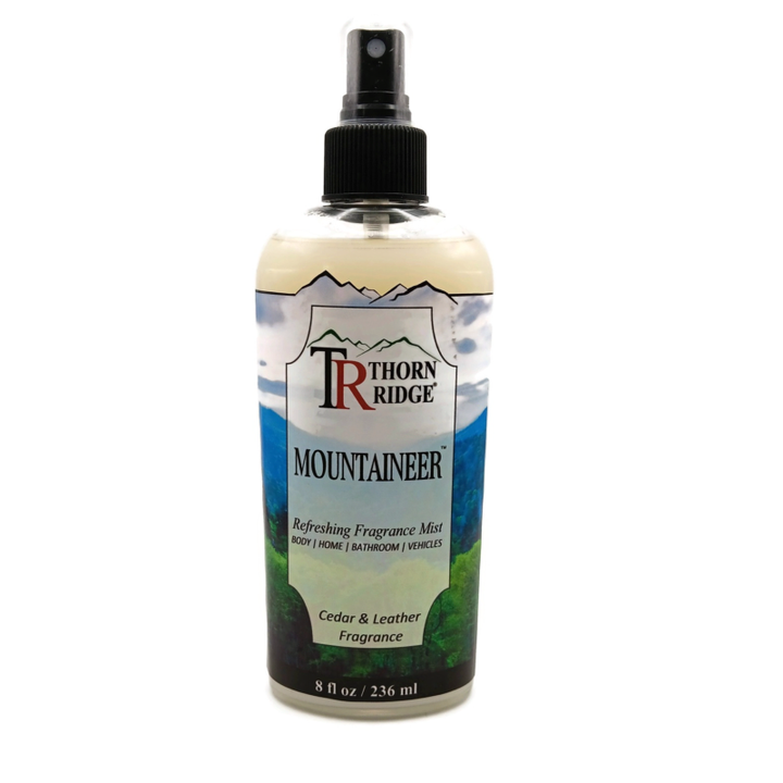 A bottle of Thorn Ridge fragrance mist labeled "Mountaineer," described as a cedar and leather  scent for body, home, bathroom, and vehicles. 8 fl oz.