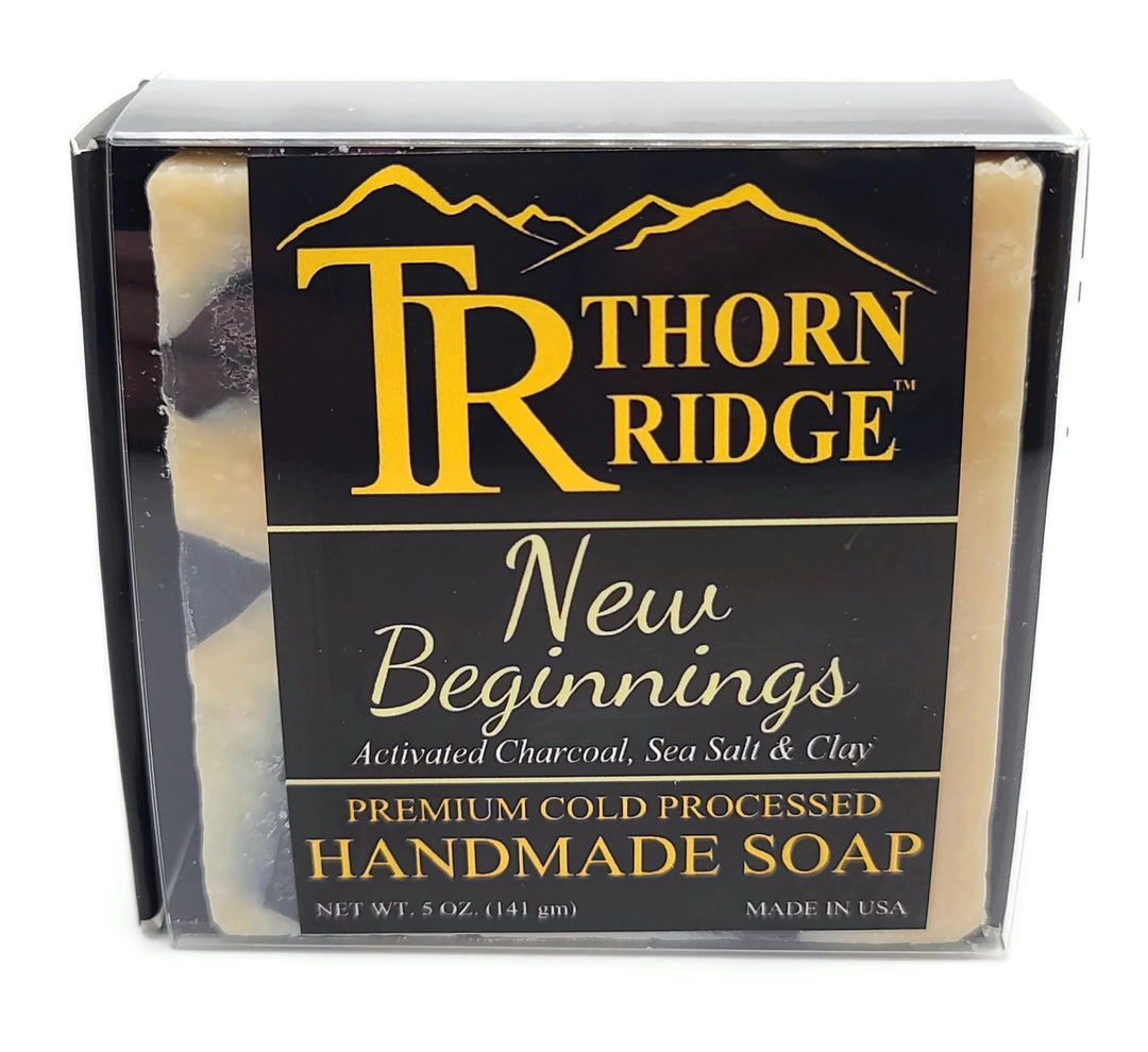 Packaging of Thorn Ridge soap labeled "New Beginnings," described as activated charcoal, sea salt, clay, premium cold processed, handmade, 5 oz. Made in USA.