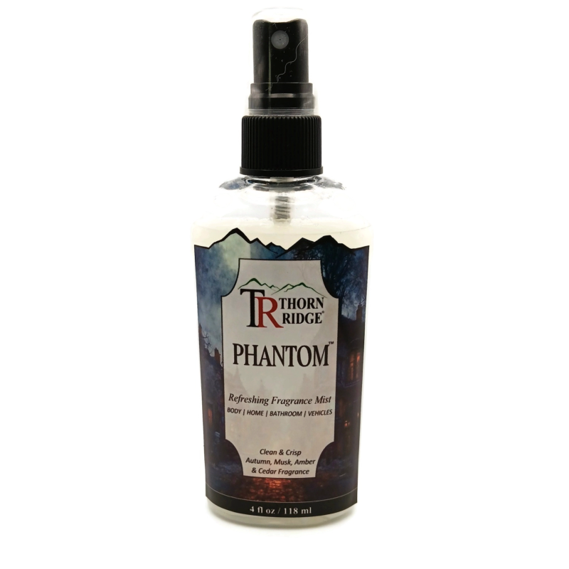 A bottle of Thorn Ridge fragrance mist labeled "Phantom," described as a clean and crisp autumn, musk, amber, and cedar scent for body, home, bathroom, and vehicles. 4 fl oz.