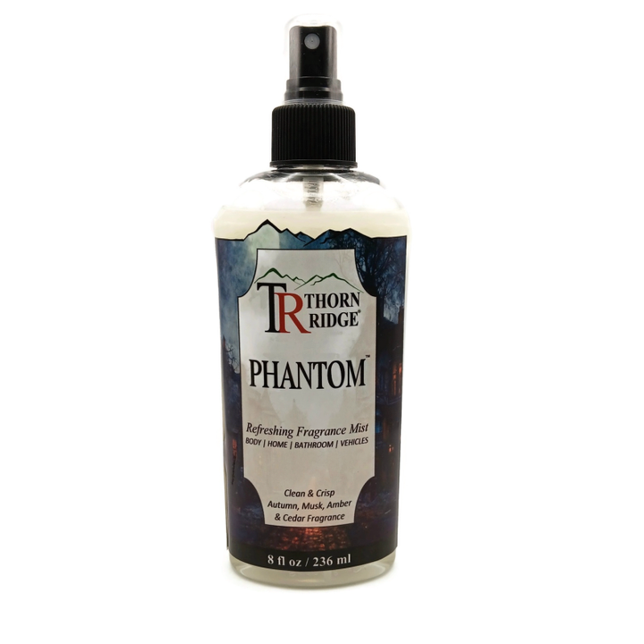 A bottle of Thorn Ridge fragrance mist labeled "Phantom," described as a clean and crisp autumn, musk, amber, and cedar scent for body, home, bathroom, and vehicles. 8 fl oz.