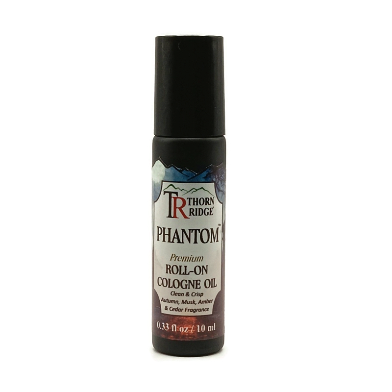 A bottle of Thorn Ridge roll on cologne labeled "Phantom," described as a clean and crisp, autumn, musk, amber and cedar fragrance. 0.33 fl oz, 10 ml.