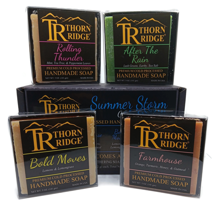 Packaging of Thorn Ridge soap gift set labeled "Summer Storm Collection," described as containing 4 individually packaged soaps, lathering soap bag, mini mat, premium cold processed, handmade, 5 oz each (1 lb 4 oz), Made in USA.