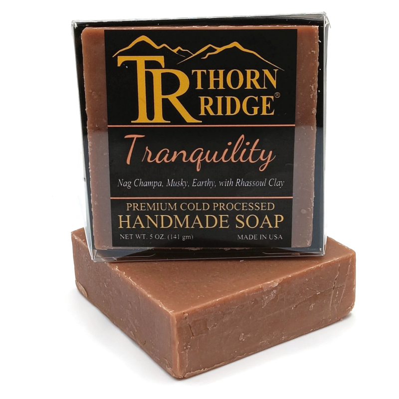 Packaging of Thorn Ridge soap labeled "Tranquility," described as nag champa, musky, earthy, with rhassoul clay, premium cold processed, handmade, 5 oz. Made in USA.