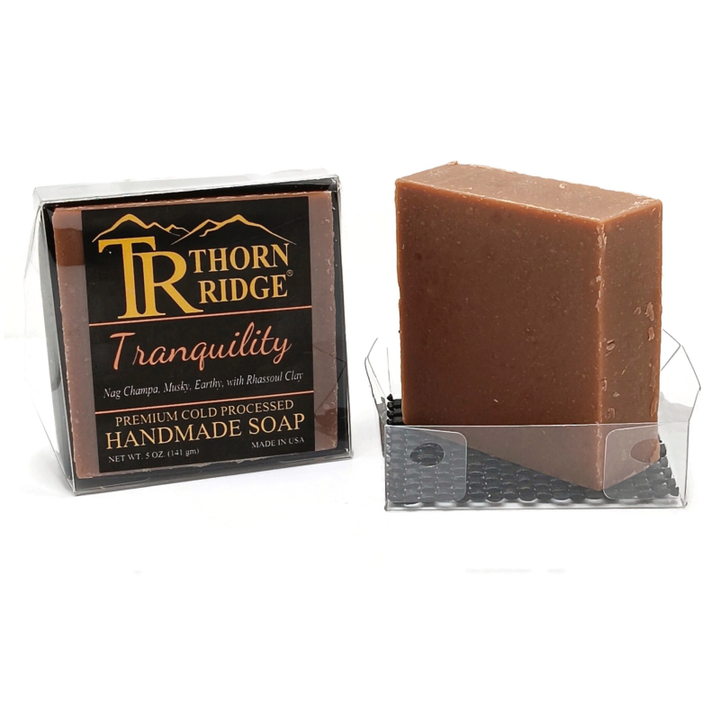 Packaging of Thorn Ridge soap labeled "Tranquility," described as nag champa, musky, earthy, with rhassoul clay, premium cold processed, handmade, 5 oz. Made in USA.