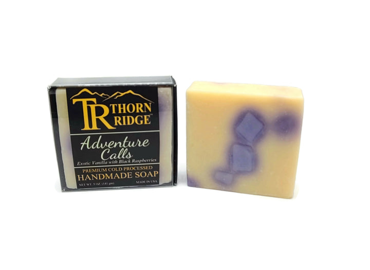 Packaging of Thorn Ridge soap labeled "Adventure Calls," described as exotic vanilla with black raspberries, premium cold processed, handmade, 5 oz. Made in USA.