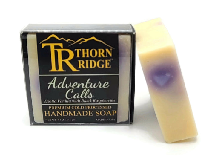 Packaging of Thorn Ridge soap labeled "Adventure Calls," described as exotic vanilla with black raspberries, premium cold processed, handmade, 5 oz. Made in USA.