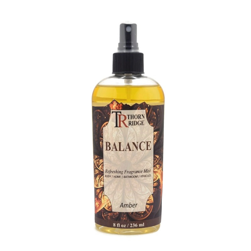 A bottle of Thorn Ridge fragrance mist labeled "Balance," described as an amber scent for body, home, bathroom, and vehicles. 8 fl oz.