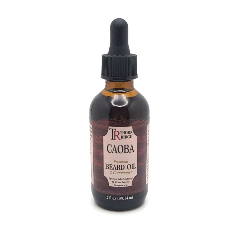 A bottle of Thorn Ridge beard oil labeled "Caoba," described as a premium beard oil and conditioner with aspiced mahogany and palo santo fragrance. 2 fl oz.