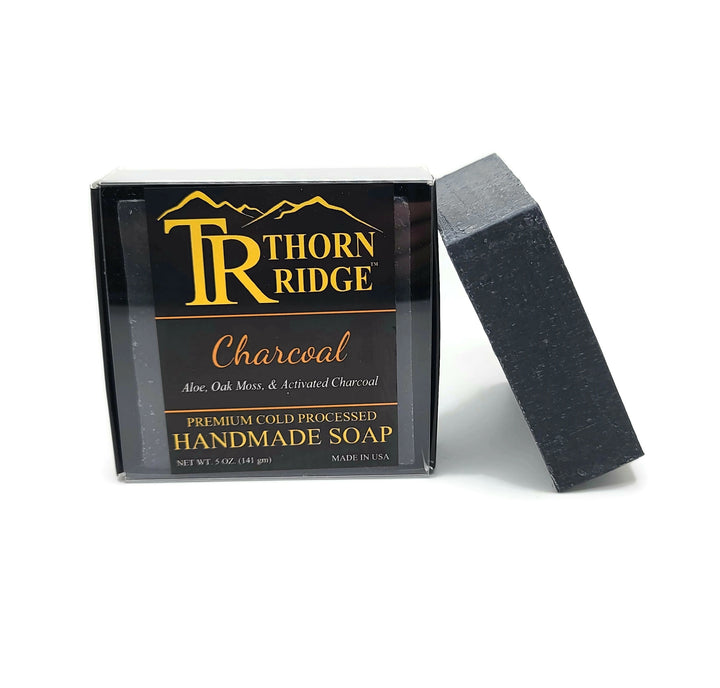 Packaging of Thorn Ridge soap labeled "Charcoal," described as aloe, oak moss, activated charcoal, premium cold processed, handmade, 5 oz. Made in USA.