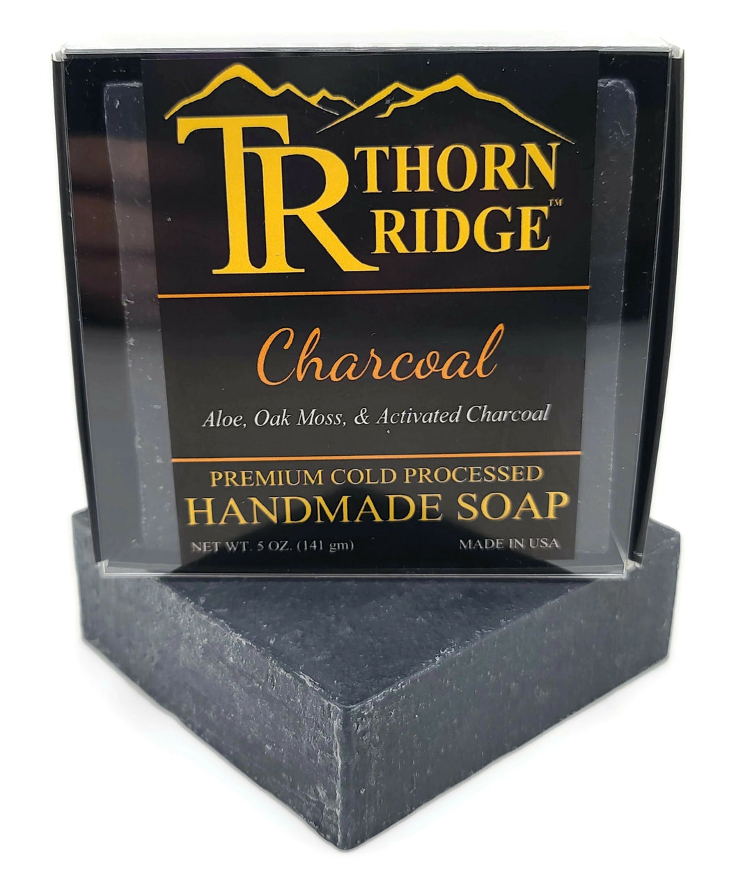 Packaging of Thorn Ridge soap labeled "Charcoal," described as aloe, oak moss, activated charcoal, premium cold processed, handmade, 5 oz. Made in USA.