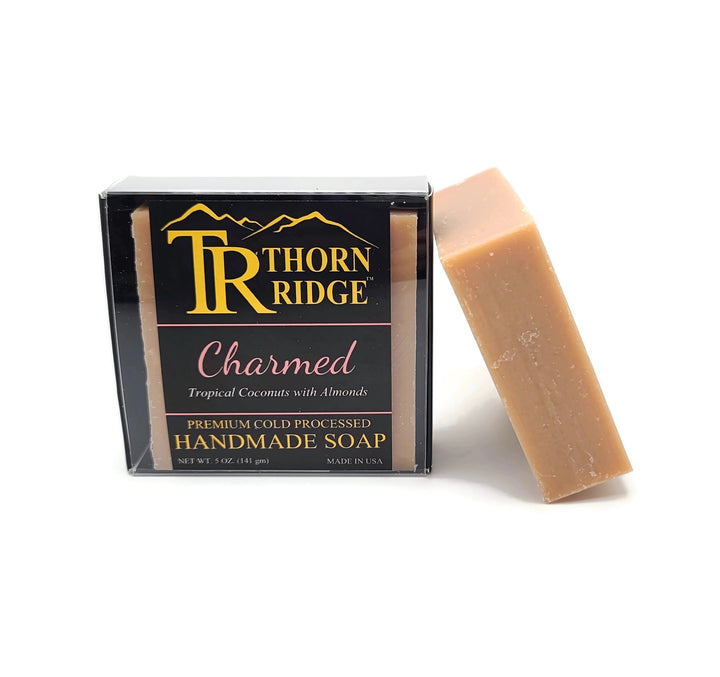 Packaging of Thorn Ridge soap labeled "Charmed," described as tropical coconuts with almonds, premium cold processed, handmade, 5 oz. Made in USA.