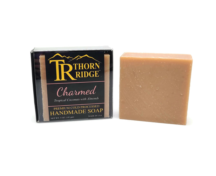 Packaging of Thorn Ridge soap labeled "Charmed," described as tropical coconuts with almonds, premium cold processed, handmade, 5 oz. Made in USA.