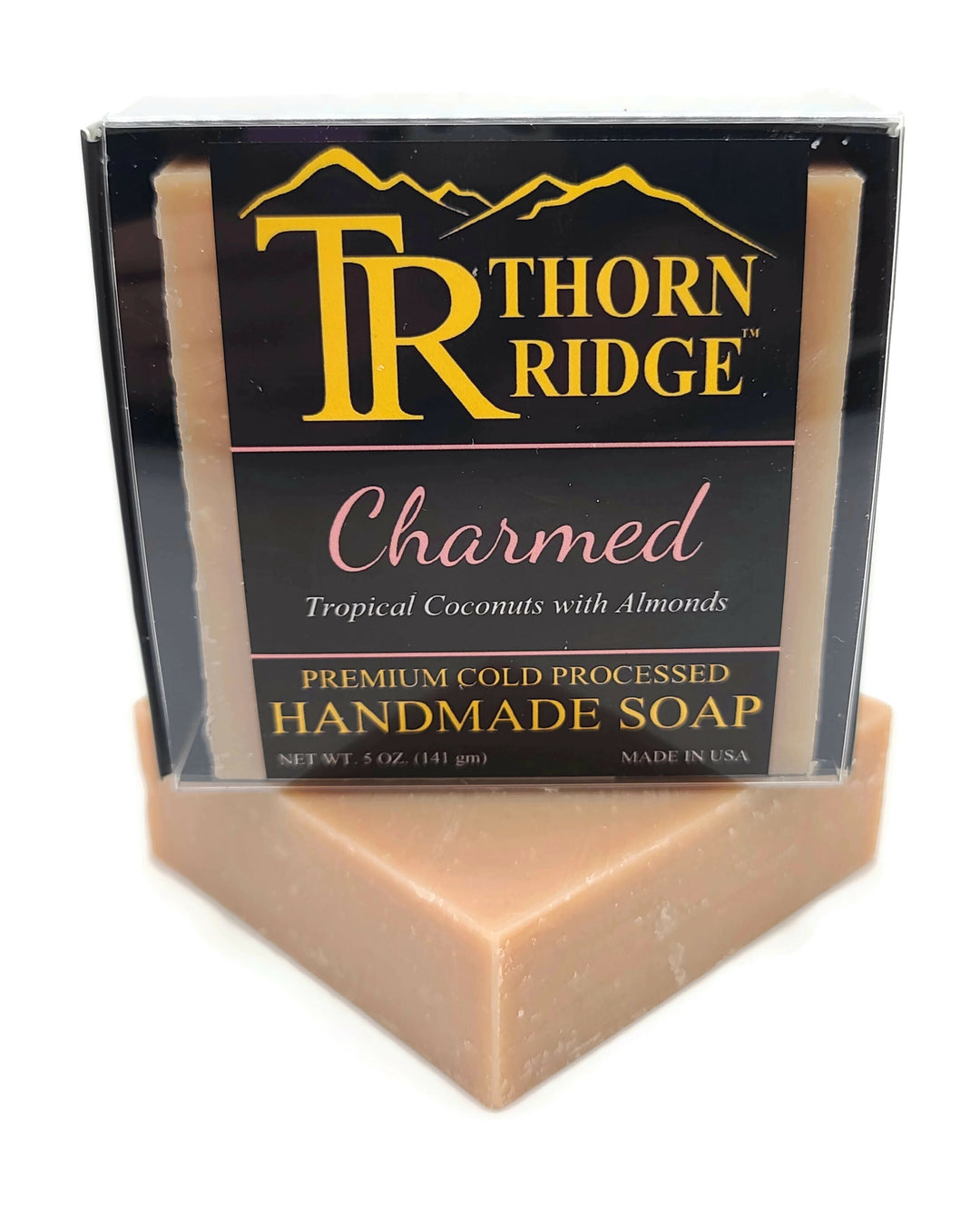 Packaging of Thorn Ridge soap labeled "Charmed," described as tropical coconuts with almonds, premium cold processed, handmade, 5 oz. Made in USA.