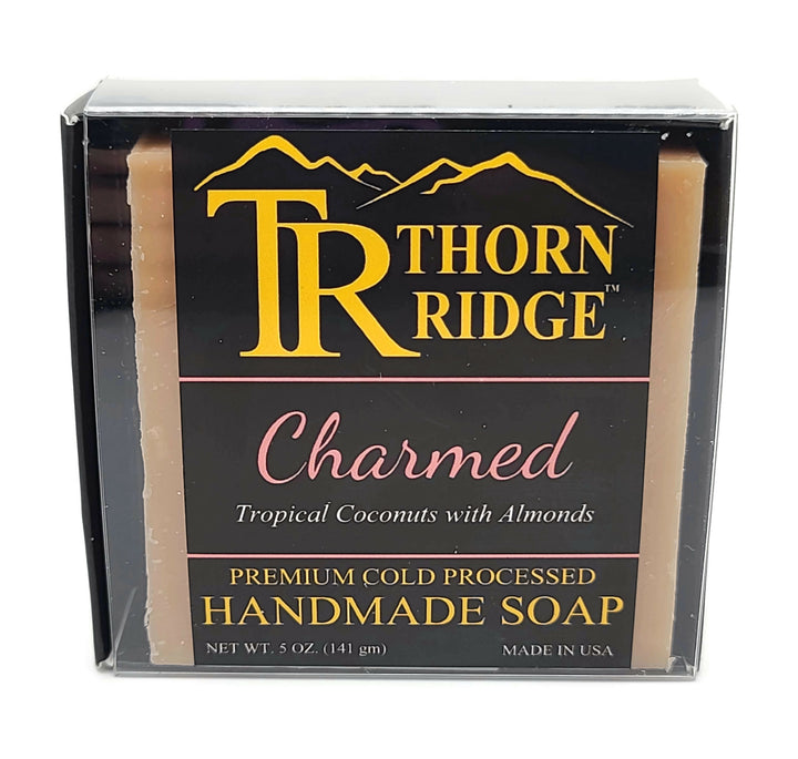 Packaging of Thorn Ridge soap labeled "Charmed," described as tropical coconuts with almonds, premium cold processed, handmade, 5 oz. Made in USA.