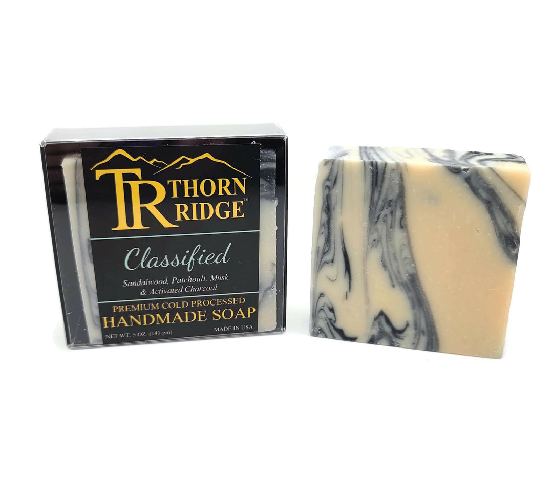 Packaging of Thorn Ridge soap labeled "Classified," described as sandalwood, patchouli, musk, and activated charcoal, premium cold processed, handmade, 5 oz. Made in USA.