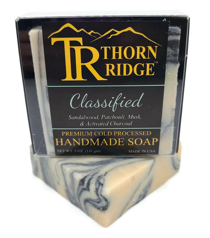 Packaging of Thorn Ridge soap labeled "Classified," described as sandalwood, patchouli, musk, and activated charcoal, premium cold processed, handmade, 5 oz. Made in USA.