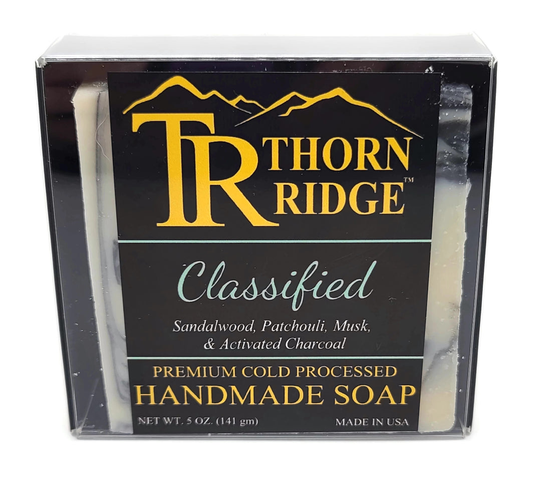 Packaging of Thorn Ridge soap labeled "Classified," described as sandalwood, patchouli, musk, and activated charcoal, premium cold processed, handmade, 5 oz. Made in USA.