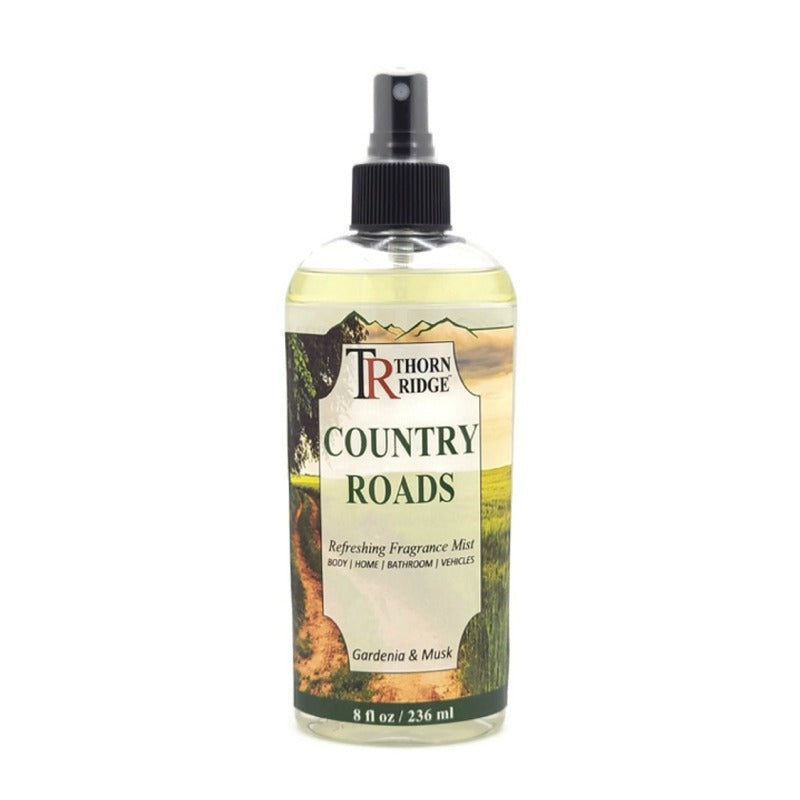 A bottle of Thorn Ridge fragrance mist labeled "Country Roads," described as a gardenia and musk  scent for body, home, bathroom, and vehicles. 8 fl oz.