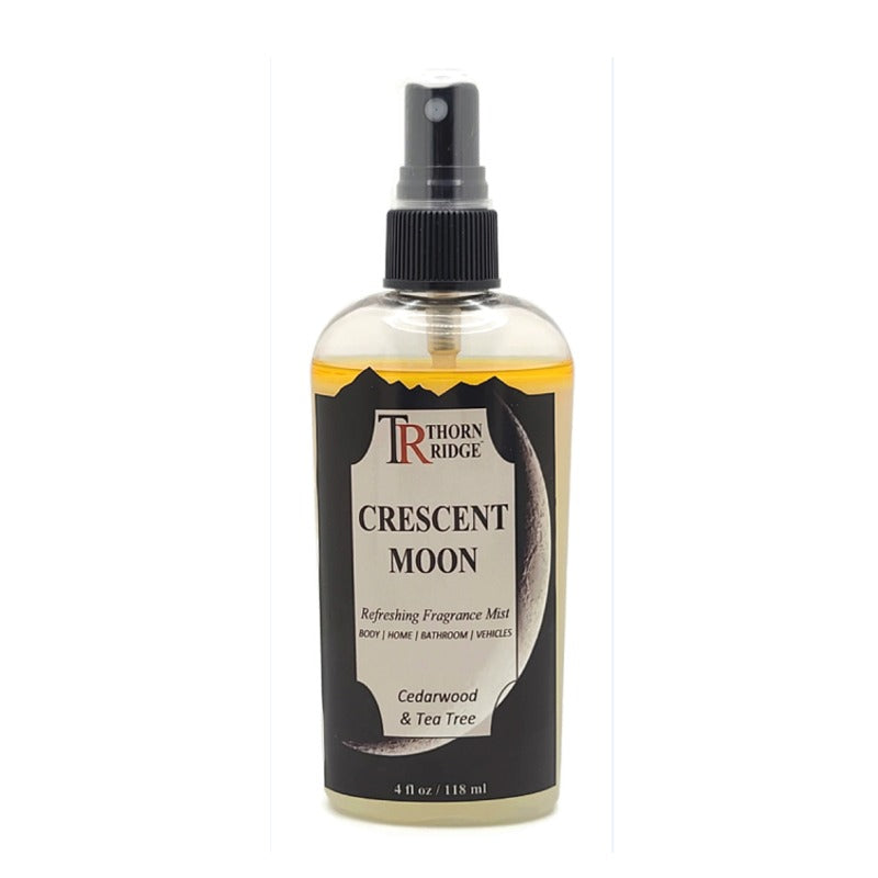 A bottle of Thorn Ridge fragrance mist labeled "Crescent Moon," described as a cedarwood and tea tree scent for body, home, bathroom, and vehicles. 4 fl oz.