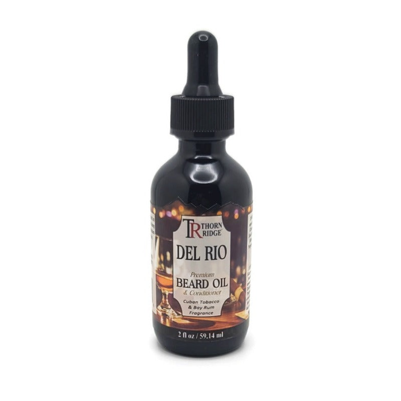 A bottle of Thorn Ridge beard oil labeled "Del Rio," described as a premium beard oil and conditioner with a Cuban tobacco and bay rum fragrance. 2 fl oz.