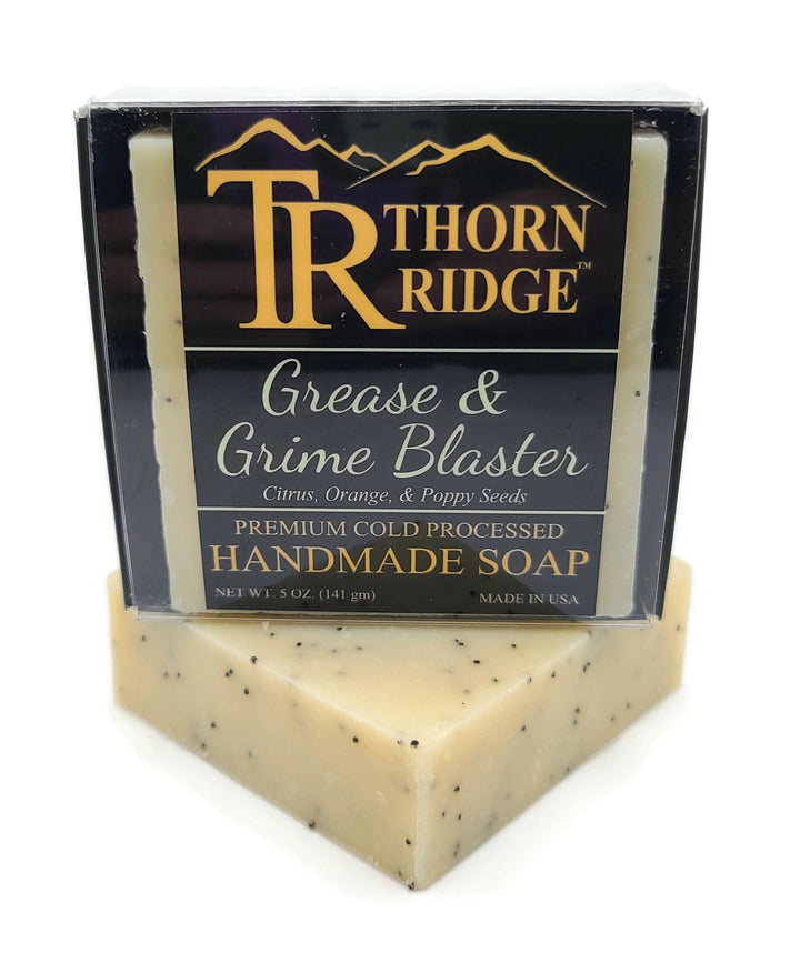 Packaging of Thorn Ridge soap labeled "Grease and Grime Blaster," described as citrus, orange, poppy seeds, premium cold processed, handmade, 5 oz. Made in USA.