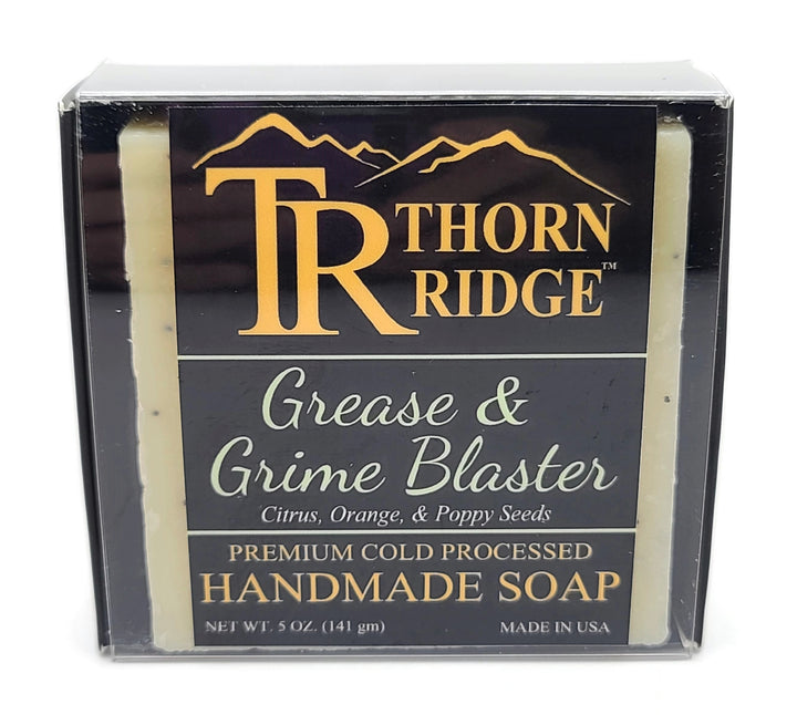 Packaging of Thorn Ridge soap labeled "Grease and Grime Blaster," described as citrus, orange, poppy seeds, premium cold processed, handmade, 5 oz. Made in USA.