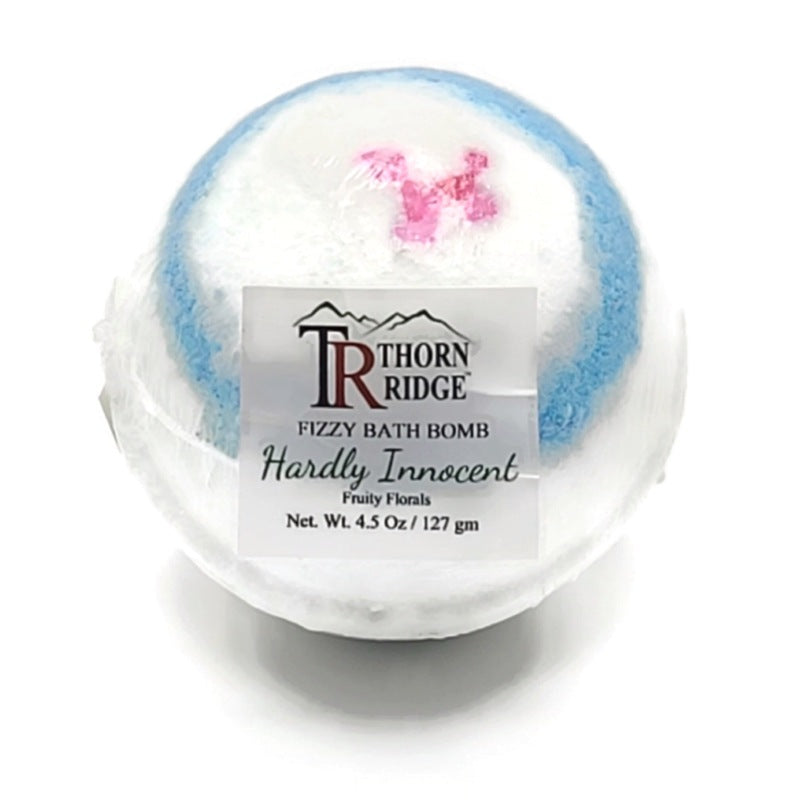 A Thorn Ridge fizzy bath bomb labeled "Hardly Innocent," described as a fruity florals fragrance. 4.5 oz.