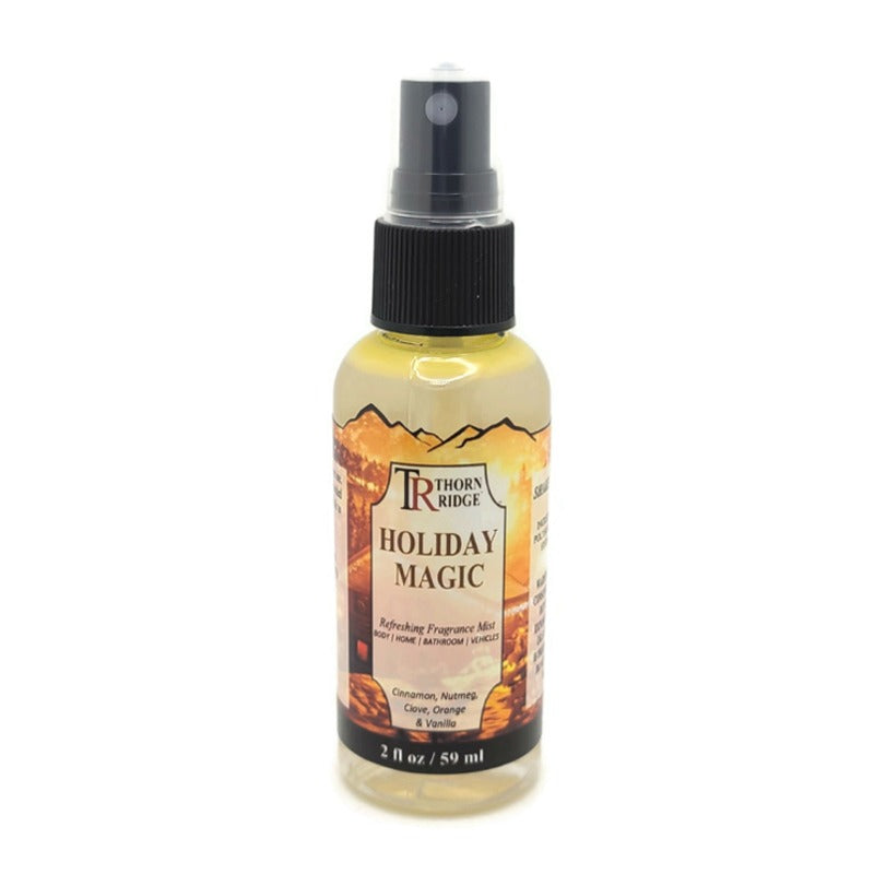 A bottle of Thorn Ridge fragrance mist labeled "Holiday Magic," described as a cinnamon, nutmeg, clove, orange, and vanilla scent for body, home, bathroom, and vehicles. 2 fl oz.