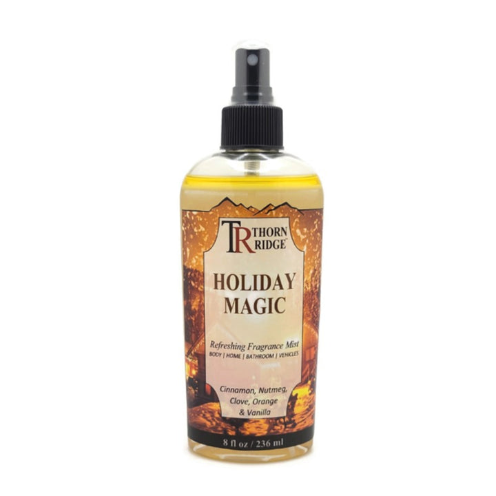 A bottle of Thorn Ridge fragrance mist labeled "Holiday Magic," described as a cinnamon, nutmeg, clove, orange, and vanilla scent for body, home, bathroom, and vehicles. 8 fl oz.