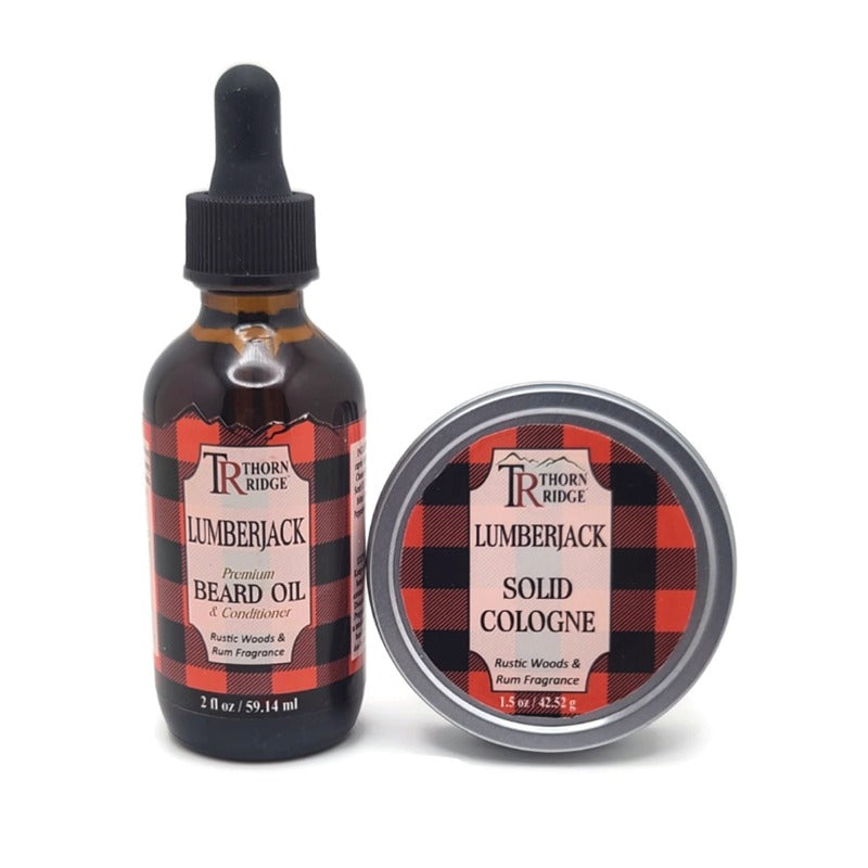 Packaging of Thorn Ridge gift set containing a 2 oz bottle of beard oil and a 1.5 oz tin can of solid cologne described as a rustic woods and rum fragrance and labeled "Lumberjack," Made in USA.