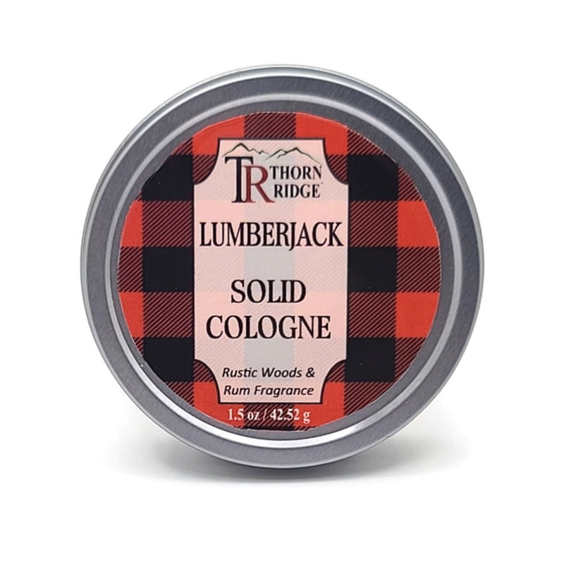 A silver tin of Thorn Ridge solid cologne labeled "Lumberjack," described as a rustic woods and rum fragrance. 1.5 oz.