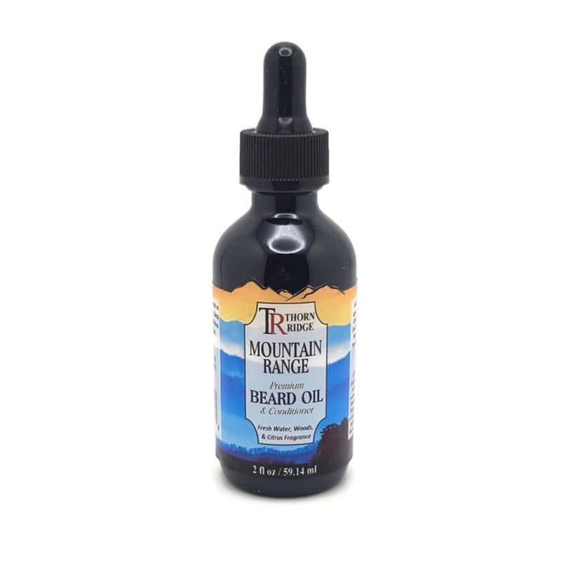 A bottle of Thorn Ridge beard oil labeled "Mountain Range," described as a premium beard oil and conditioner with a fresh water, woods, and citrus scent. 2 fl oz.