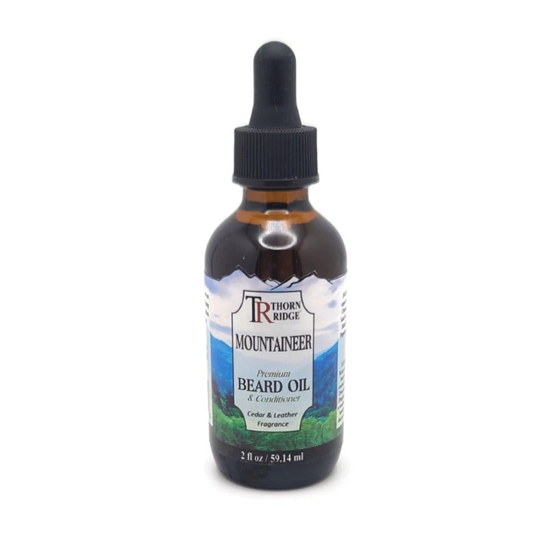 A bottle of Thorn Ridge beard oil labeled "Mountaineer," described as a premium beard oil and conditioner with a cedar and leather fragrance. 2 fl oz.