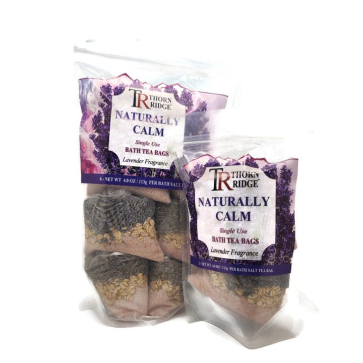 A bag of Thorn Ridge single use bath tea bag soaks labeled "Naturally Calm," described as a lavender fragrance. 4.0 oz per bath tea. 2 pack. 8 oz total. 6 pack also pictured.