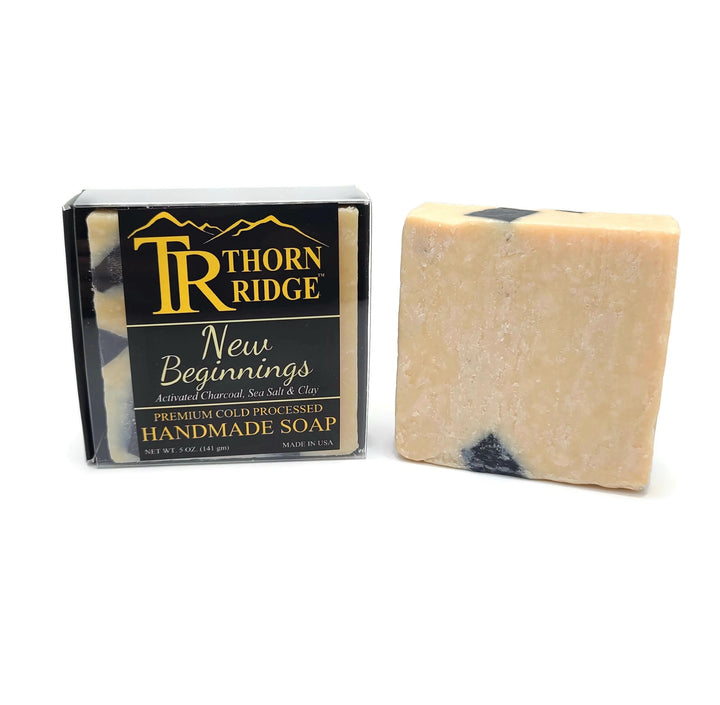 Packaging of Thorn Ridge soap labeled "New Beginnings" described as activated charcoal, sea salt, clay, premium cold processed, handmade, 5 oz. Made in USA.