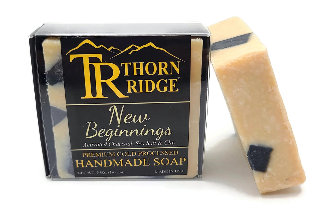 Packaging of Thorn Ridge soap labeled "New Beginnings" described as activated charcoal, sea salt, clay, premium cold processed, handmade, 5 oz. Made in USA.