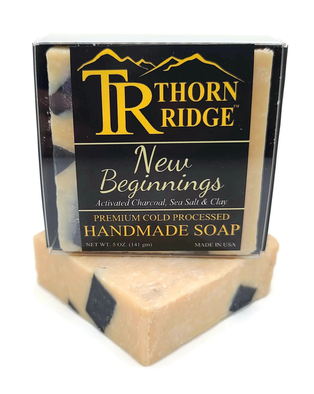 Packaging of Thorn Ridge soap labeled "New Beginnings" described as activated charcoal, sea salt, clay, premium cold processed, handmade, 5 oz. Made in USA.