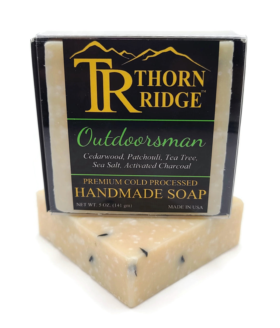 Packaging of Thorn Ridge soap labeled "Outdoorsman," described as cedarwood, patchouli, tea tree, sea salt, activated charcoal, premium cold processed, handmade, 5 oz. Made in USA.