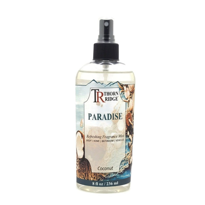 A bottle of Thorn Ridge fragrance mist labeled "Paradise," described as a coconut scent for body, home, bathroom, and vehicles. 8 fl oz.