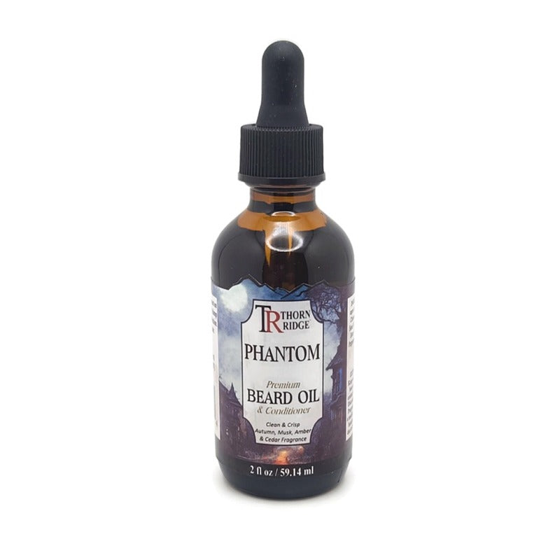 A bottle of Thorn Ridge beard oil labeled "Phantom," described as a premium beard oil and conditioner with a clean and crisp, autumn, musk, amber and cedar fragrance. 2 fl oz.